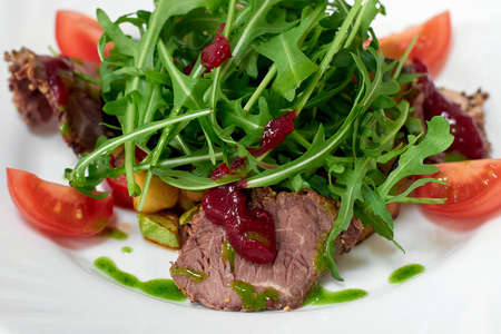 Delicious salad with beef, fresh vegetables, arugulaの写真素材