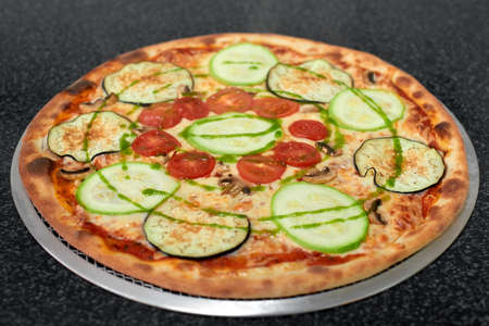 Delicious vegetarian pizza with eggplant, zucchini, tomatoes and mushroomsの写真素材