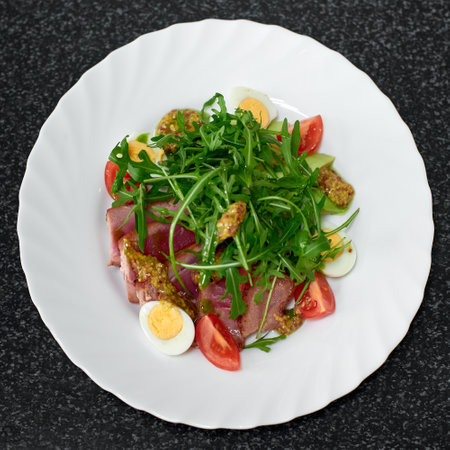 Delicious salad with medium beef, fresh vegetables, arugula and eggs. Top viewの写真素材