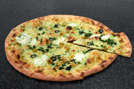 Delicious vegetarian pizza with olives and herbsの写真素材