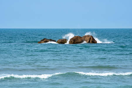 Large stones in the sea. Sea with blue water and waves. Seascape. Natural backgroundの写真素材