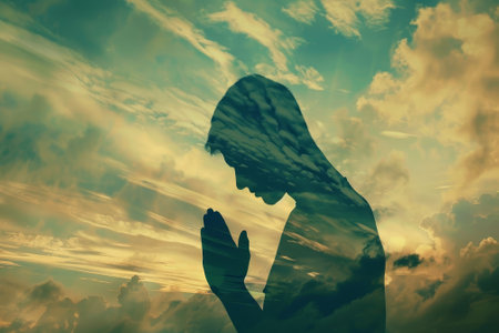 A person praying in front of a cloudy sky. The sky is filled with clouds, and the person is praying with their hands clasped togetherの素材