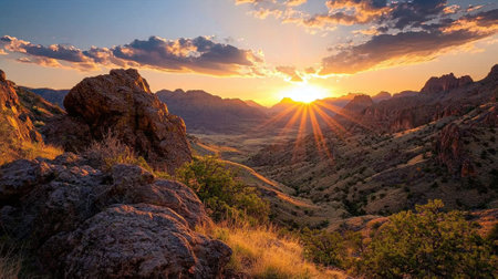 A beautiful sunset over a mountain range with a bright sun shining through the clouds. The sky is a mix of orange and pink hues, creating a serene and peaceful atmosphereの素材