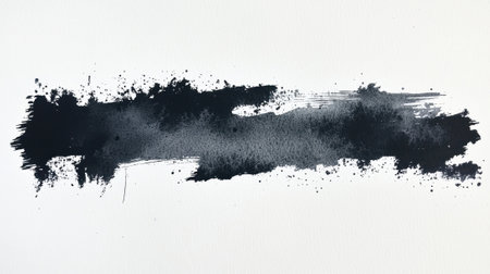 A bold black brushstroke stretches across a white canvas, showing contrasting shades and textures. The splatters enhance its dynamic and expressive quality, inviting interpretation.の素材