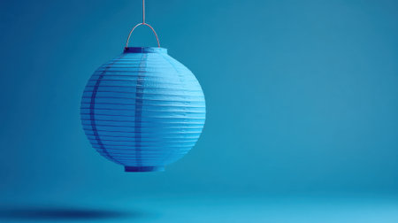 A beautiful blue lantern hangs in a serene setting creating a soothing atmosphere perfect for relaxation.の素材