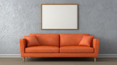 A orange cozy sofa sits proudly against a soft gray wall inviting creativity with its empty frame.の素材