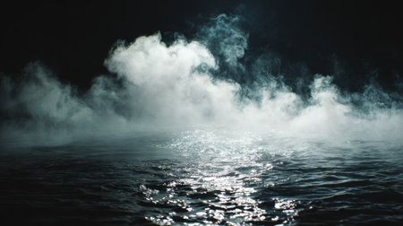 Soft mist swirls above the calm water creating a serene and mysterious atmosphere at night.の素材