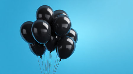 Balloons rise gracefully in the air their glossy surfaces reflecting the vibrant blue around them.の素材