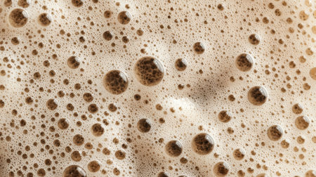 Close-up view of a frothy drink showing numerous bubbles on its surface. This scene captures the refreshing texture and creamy appearance of the beverage.の素材