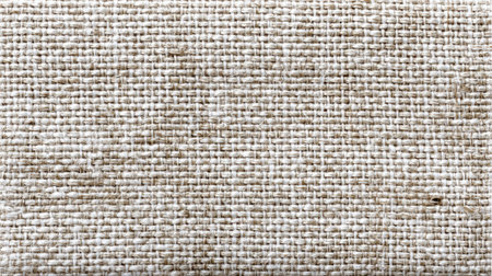 A textured fabric surface features a natural woven pattern in light beige hues, ideal for home decor, clothing design, or crafting projects. The subtle variations enhance its visual appeal.の素材