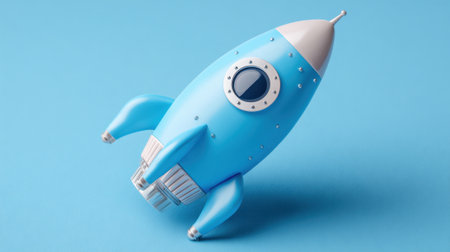 A cheerful blue rocket toy sits on a smooth pastel background ready for adventure and dreams.の素材
