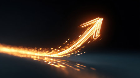 A bright golden arrow made of light is seen curving upward against a black background representing motivation and advancement. The radiant sparkles enhance the feeling of dynamism.の素材