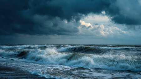 Waves crash against the shore under a cloudy sky as storm clouds gather. The atmosphere is tense and dramatic capturing the raw power of nature during the evening.の素材