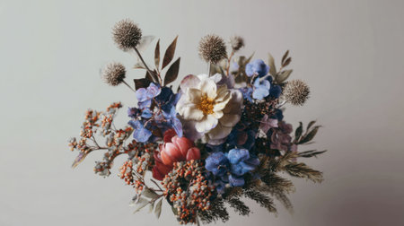 A stunning arrangement of dried flowers showcases various colors and textures, including blue, pink, and white blooms. The composition highlights natural beauty and artistic design.の素材