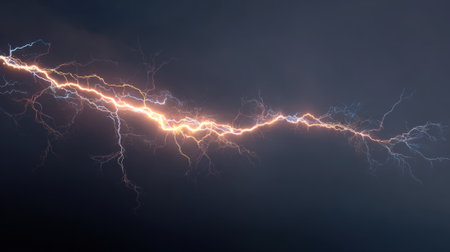 Bright lightning bolts illuminate the dark sky during a thunderstorm. The intense display of electricity creates dynamic patterns showing natures power.の素材