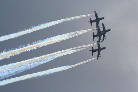 Aerobatic jet planes performing maneuvers during an air show.の写真素材