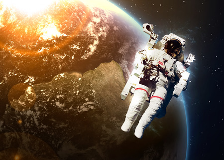 Astronaut in outer space against the backdrop of the planet earth. 
