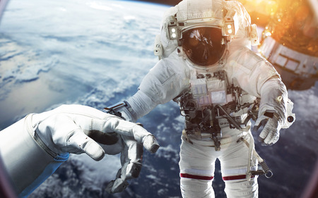 Brave astronaut at the spacewalk at the Earth orbit. People in space.