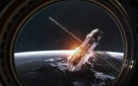 Earth planet and satellite in the International Space Station window.