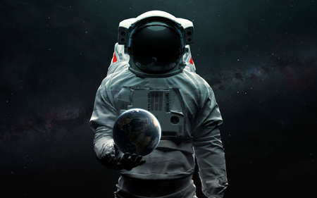Astronaut holding Earth planet in hand. 3D sci-fi art.の写真素材