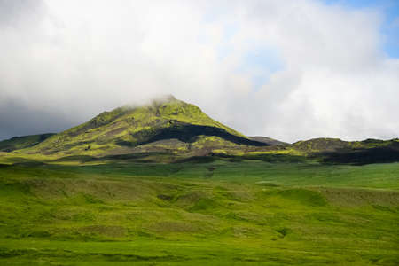 View of Icelandic misty hills against smoky clouds backgroundの写真素材