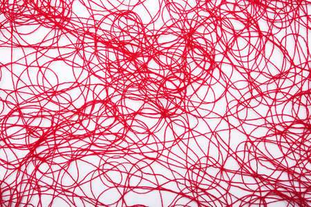 abstract background of chaotic lines formed by a red thread