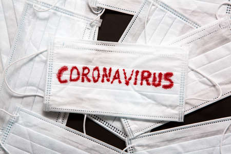 Concept of a coronavirus pandemic. Medical Disposable Face Mask with covid-19 printed on it....