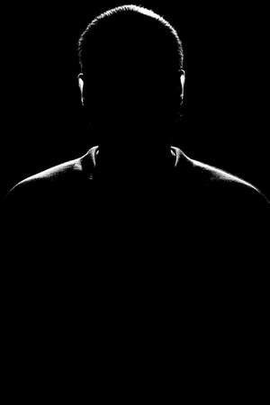 Silhouette of a man on a black background. Black and white photo.の写真素材