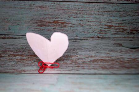 Children's congratulations with a paper heart on Valentine's Dayの写真素材