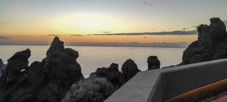 sunset on the calm coast of Los Gigantes cliff