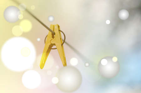 Closeup of Colorful clothes peg on a rope isolated on light background