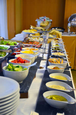 Buffet served table with snacks,fruits,canape,sweets and appetizers.Catering event plate service.Smorgasbord,food choice of breakfast in a restaurantの写真素材