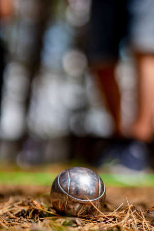 Close up of metallic petanque ball on the ground against the blurred background.Sport, relax, recreation and leisure conceptの写真素材