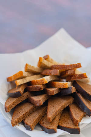 Top view of sliced wholegrain bread on a white plateの写真素材