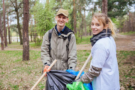 Volunteers collecting garbage in parkの写真素材