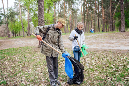 Volunteers collecting garbage in parkの写真素材