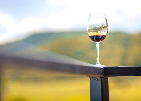 A glass of red wine on ledgeの写真素材
