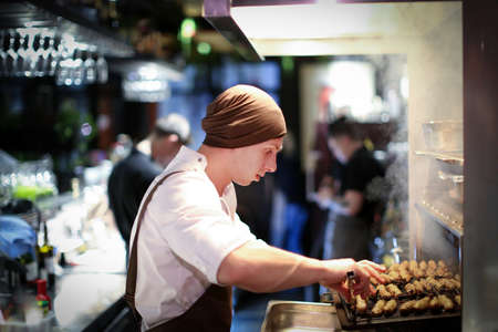 Chef man cooking in the kitchenの写真素材