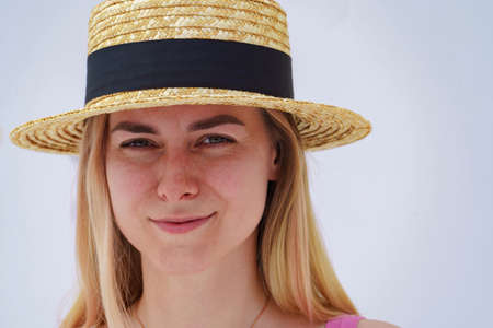 Beautiful blonde in a straw hatの写真素材