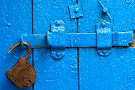 Old padlock on wooden weathered door