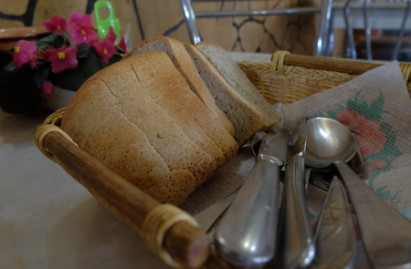 Bread in Plate with Spoons and Knifesの写真素材