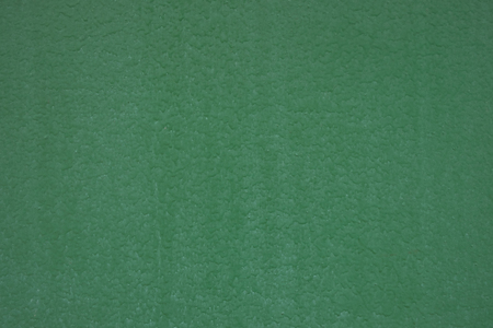 Green painted metal surface closeup as textureの写真素材