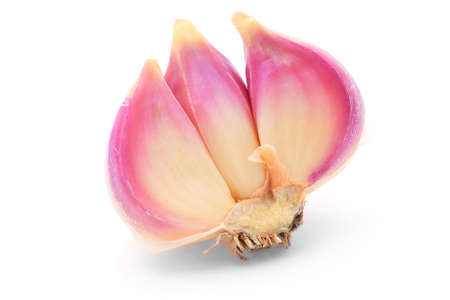 Three garlic cloves isolated on white background.の写真素材