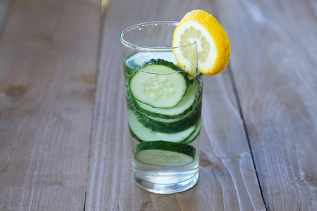 Images of glass of freshness water with cucumber on wooden background.の写真素材