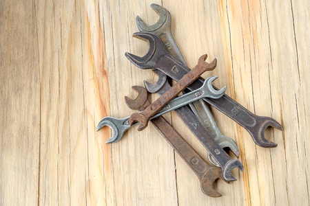 Old work tools spanner, wrench on a wooden table. Top view with empty spaceの写真素材