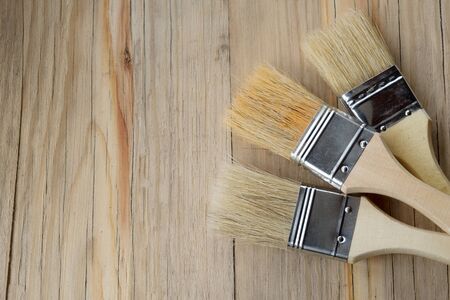 Paint brushes on a wooden table with empty spaceの写真素材