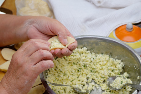 Modeling of homemade delicious vareniki, dumpling or pelmeni . Close Up.の写真素材