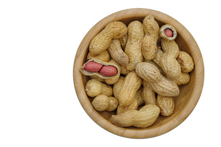 Dried peanuts in wooden bowl isolatd on white background. Top view.
