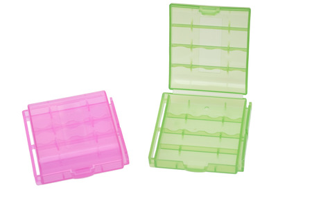 Two plastic battery pink and green holder isolated on white backgroundの写真素材
