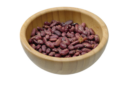 Raw red bean in wooden bowl and isolated on white background. Selective Focusの写真素材